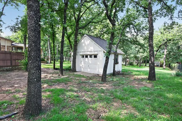 a view of a house with a tree in a forest