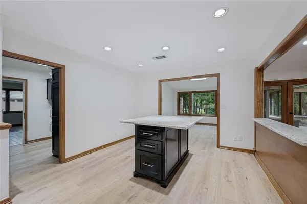 a kitchen with a stove a refrigerator and wooden floor