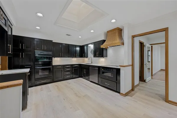 a kitchen with stainless steel appliances granite countertop a stove and a refrigerator