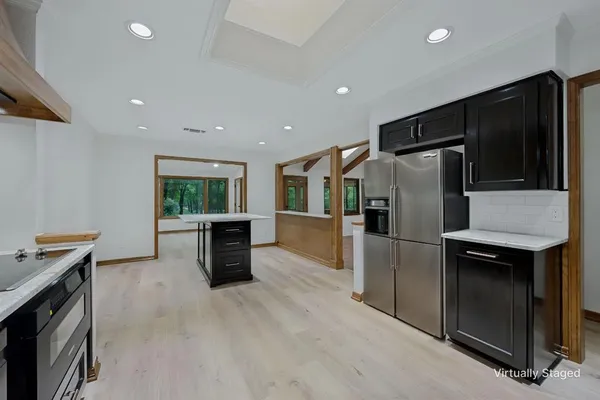 a kitchen with stainless steel appliances a refrigerator and a stove top oven