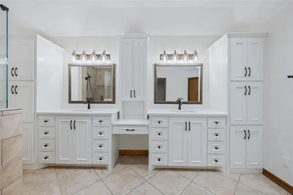 a bathroom with a sink vanity and mirror
