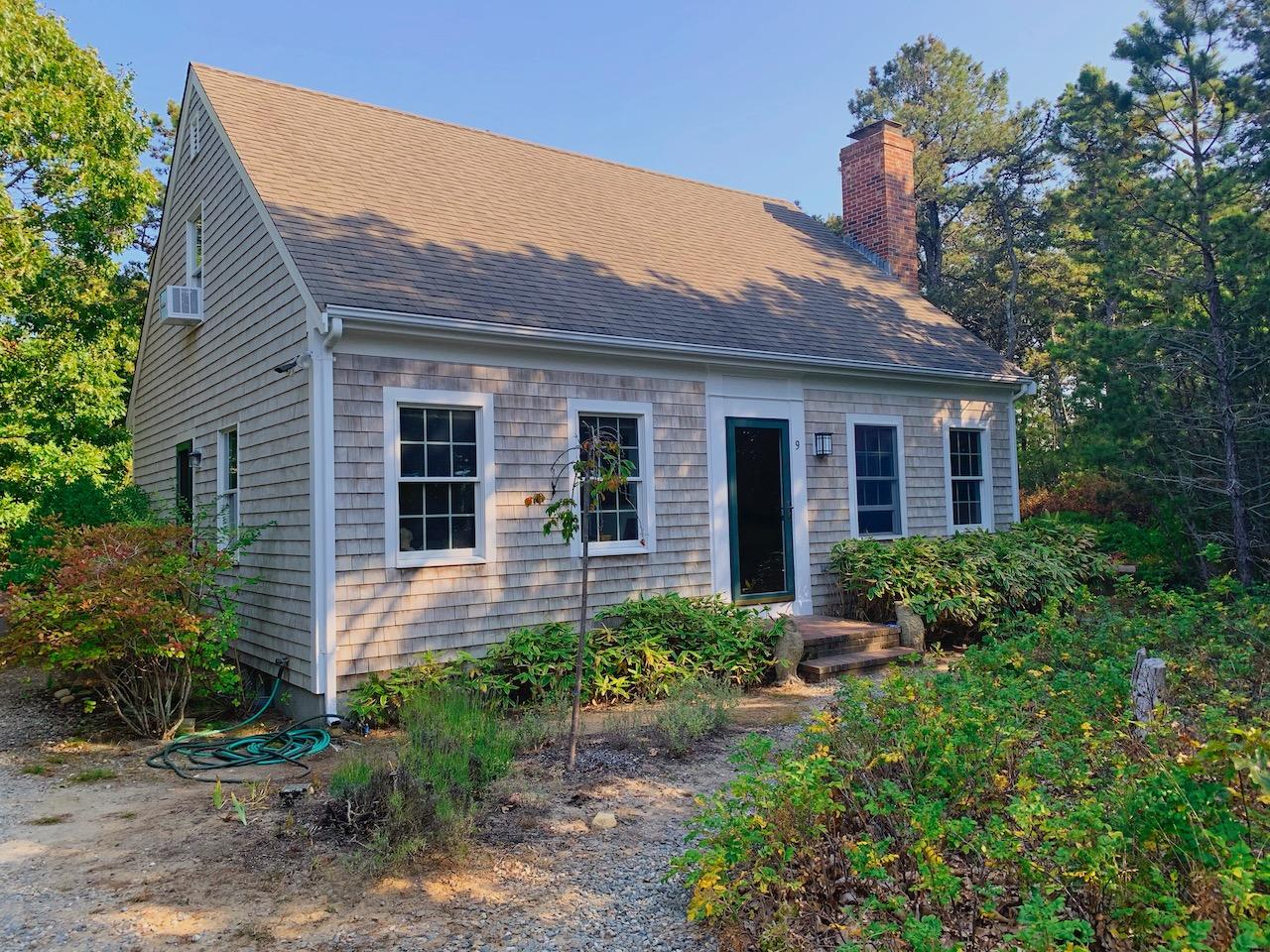 a front view of a house with garden and porch