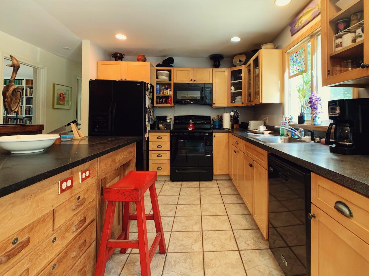 9 Sandy Lane Truro, MA 02666 - Photo 5 of 13 a kitchen with stainless steel appliances granite countertop a sink and cabinets