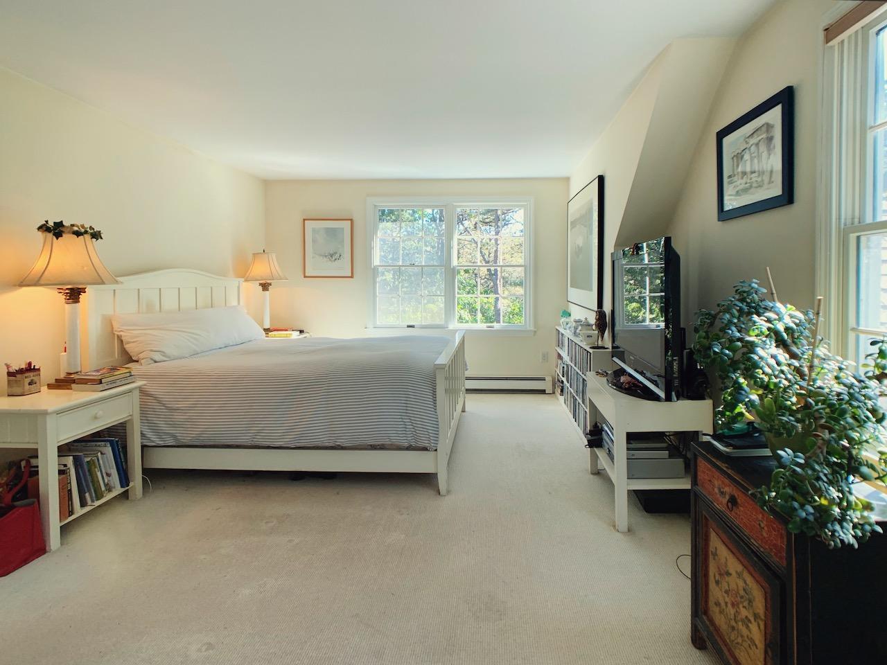 9 Sandy Lane Truro, MA 02666 - Photo 9 of 13 a bedroom with a bed chair and a large window