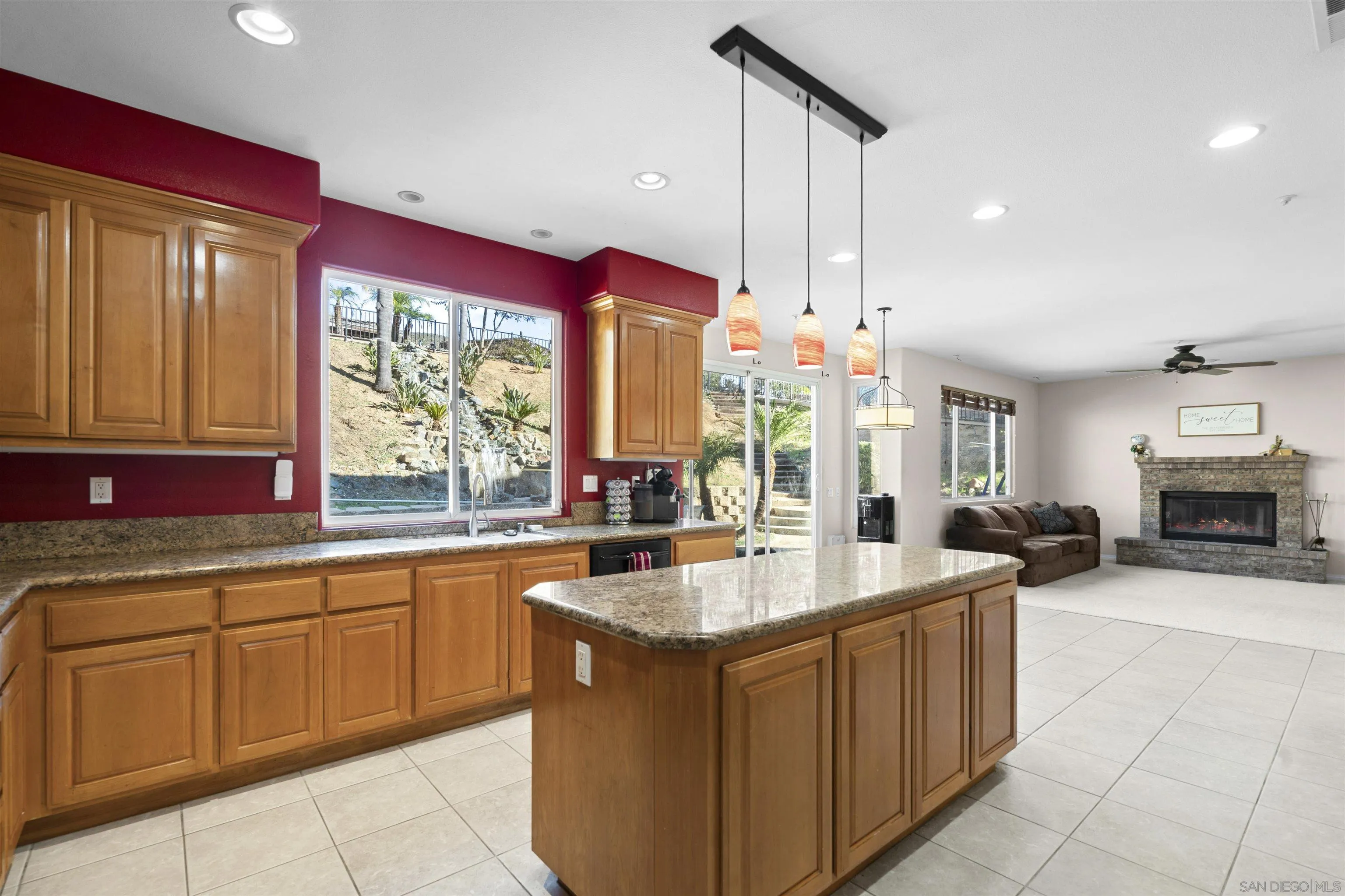 24534 Rutherford Road Ramona, CA 92065 - Photo 9 of 19 a kitchen with sink a stove and living room view
