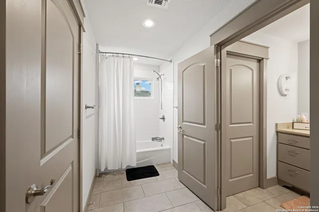 a bedroom with furniture and a window