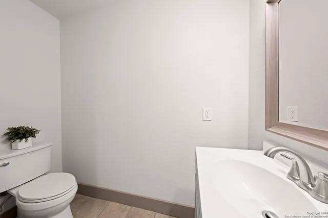 a bedroom with furniture and a large window