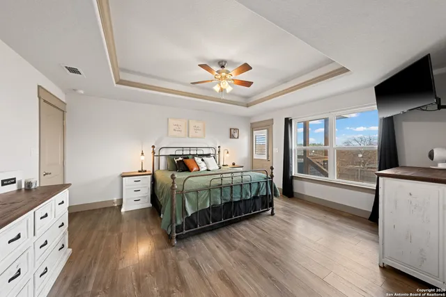 a large bathroom with a tub sink and mirror