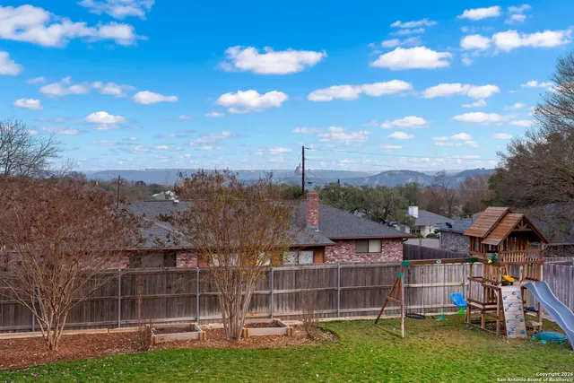 a view of a porch with chairs and backyard