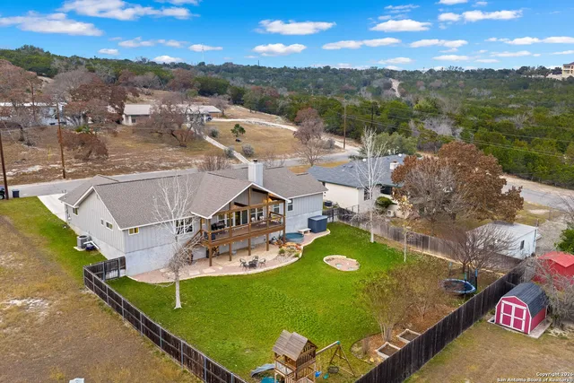 an aerial view of residential houses with outdoor space