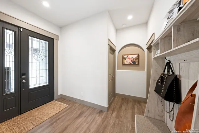 a kitchen with stainless steel appliances a dining table chairs refrigerator and sink