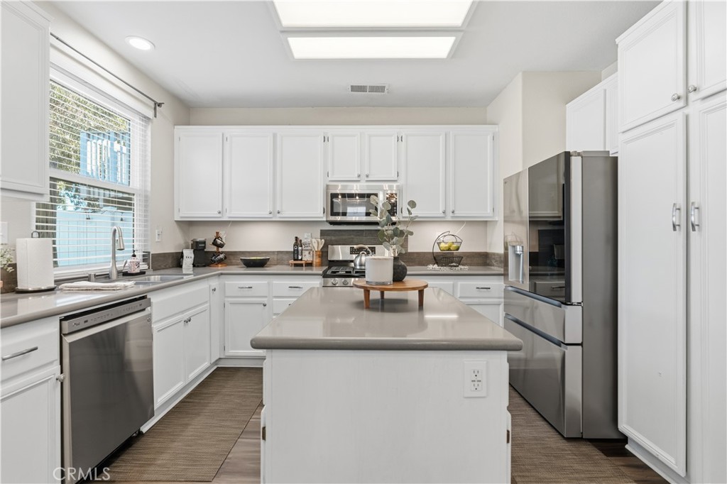 42156 Chestnut Drive Temecula, CA 92591 - Photo 11 of 33 a kitchen with stainless steel appliances granite countertop a refrigerator a stove a sink and a microwave