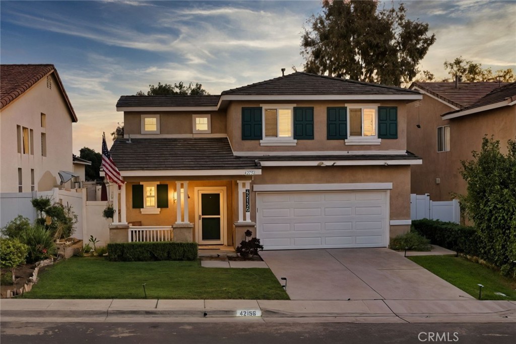 42156 Chestnut Drive Temecula, CA 92591 - Photo 2 of 33 a front view of a house with a yard and garage