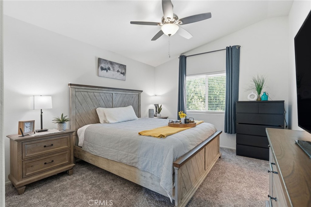 42156 Chestnut Drive Temecula, CA 92591 - Photo 21 of 33 a bedroom with a bed and a chandelier