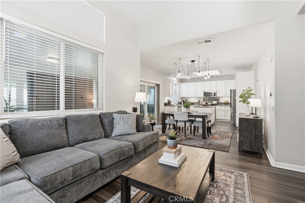 42156 Chestnut Drive Temecula, CA 92591 - Photo 7 of 33 a living room with furniture and a dining table with wooden floor
