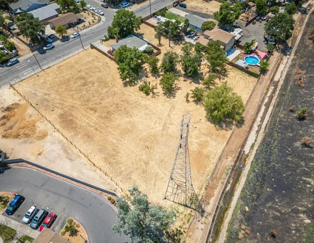 an aerial view of residential house with pool and lawn chairs