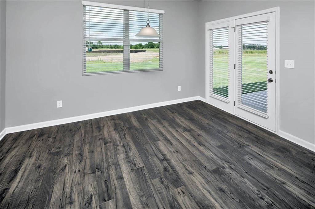 205 Lauritsen Way Newnan, GA 30265 - Photo 10 of 22 a view of an empty room with wooden floor and a window