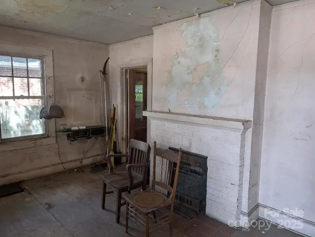 a view of a livingroom with furniture and a fireplace