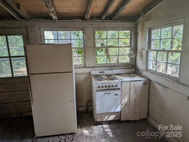 a kitchen with a refrigerator and window