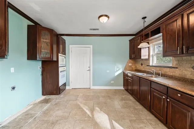 a spacious bathroom with a granite countertop sink and a mirror