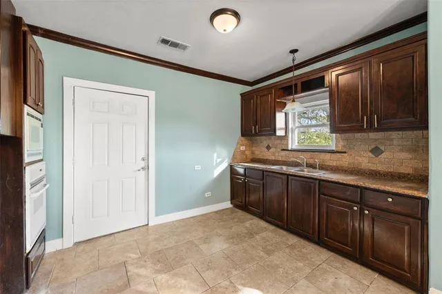 a spacious bathroom with a granite countertop sink and a mirror