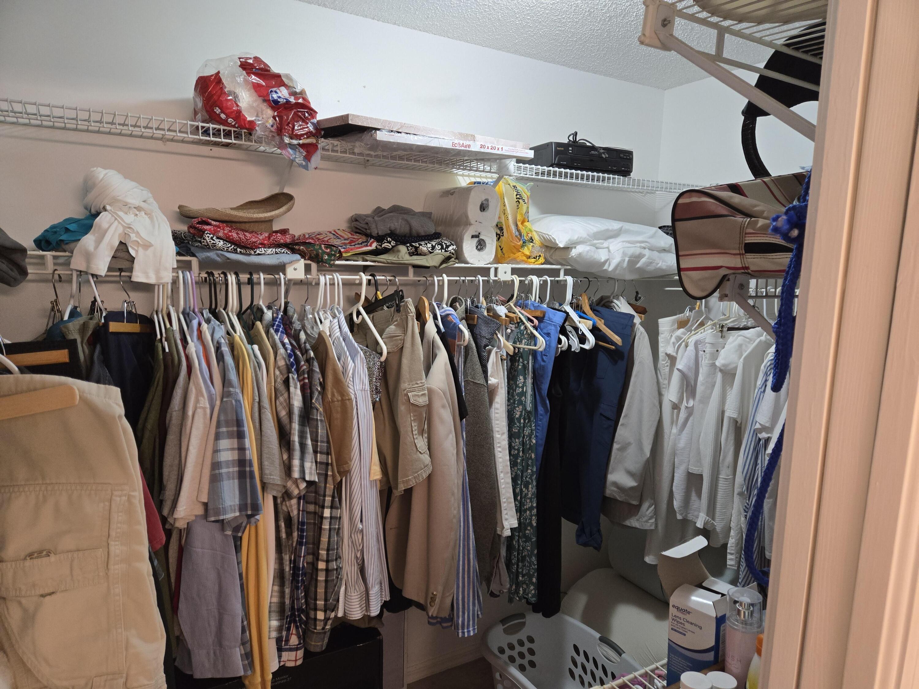 390 Main Street Sebastian, FL 32958 - Photo 12 of 18 a view of walk in closet with clothes and shoes