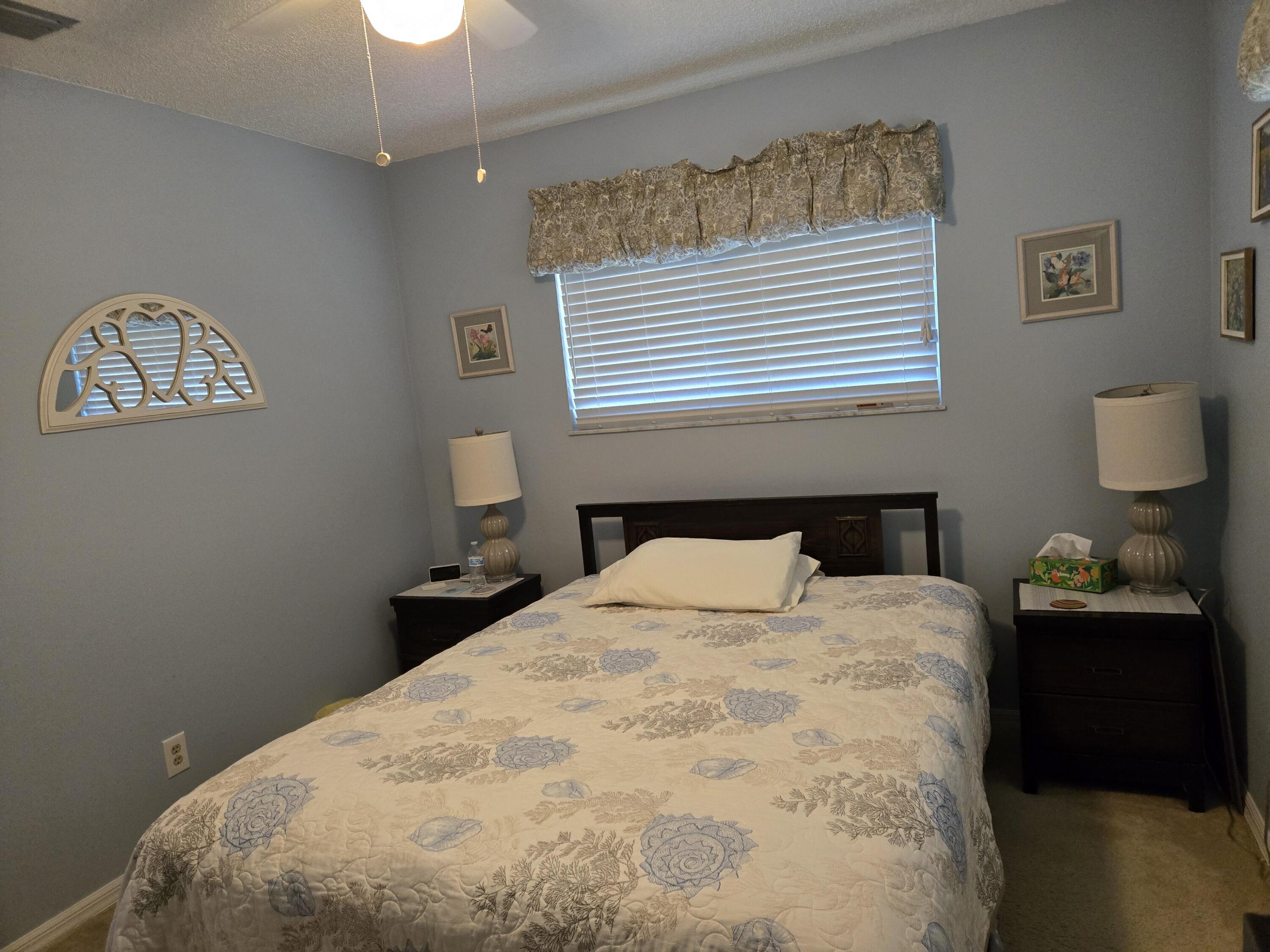 390 Main Street Sebastian, FL 32958 - Photo 13 of 18 a bedroom with a bed and a lamp