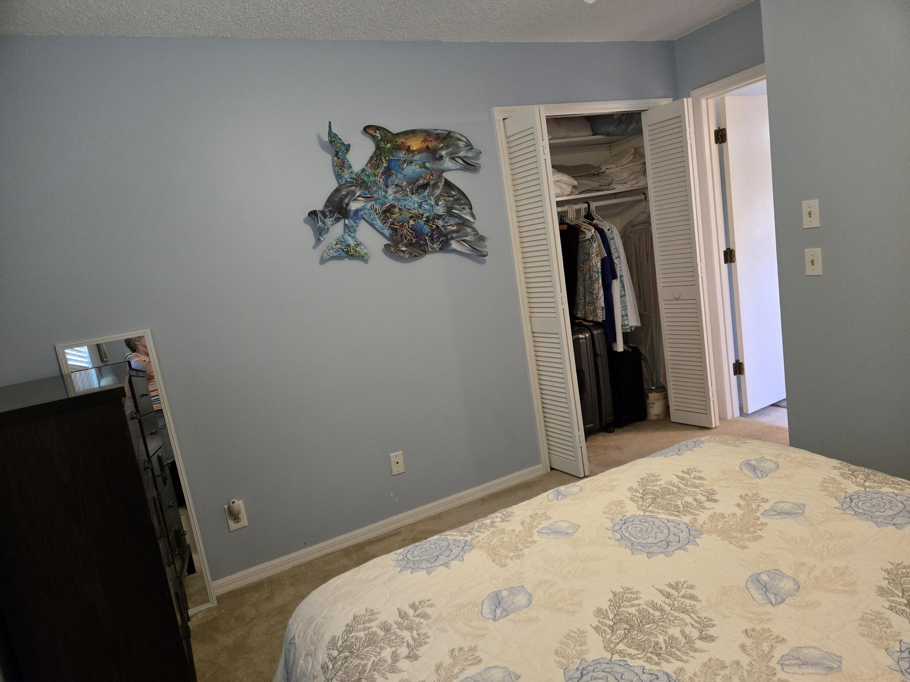 390 Main Street Sebastian, FL 32958 - Photo 14 of 18 a bedroom with a bed and a mirror