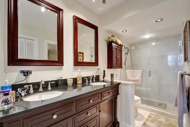 a white toilet next to a bathroom