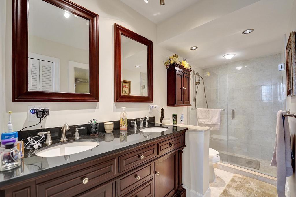2000 South Ocean Boulevard, Unit 4C Lauderdale-by-the-Sea, FL 33062 - Photo 23 of 49 a bathroom with double vanity and a mirror