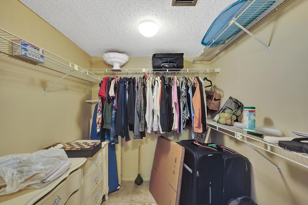 2000 South Ocean Boulevard, Unit 4C Lauderdale-by-the-Sea, FL 33062 - Photo 26 of 49 a view of walk in closet with clothes and shoes