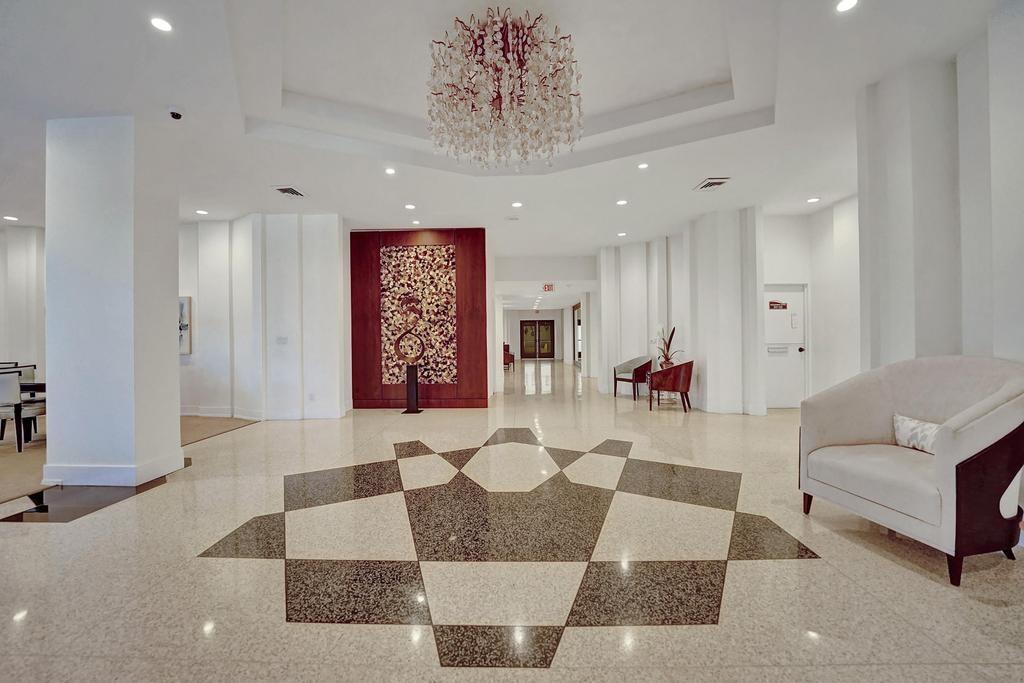 2000 South Ocean Boulevard, Unit 4C Lauderdale-by-the-Sea, FL 33062 - Photo 36 of 49 a living room with furniture and a chandelier