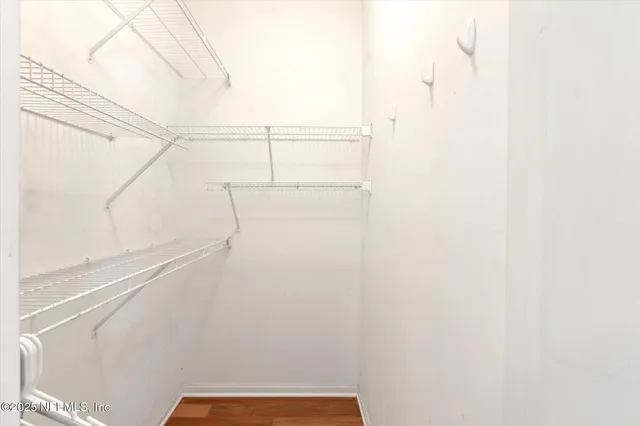 a view of walk in closet with clothes