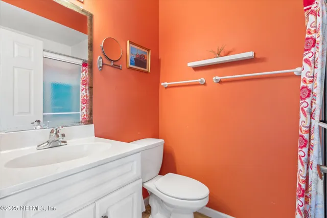 a bathroom with a sink mirror vanity and toilet