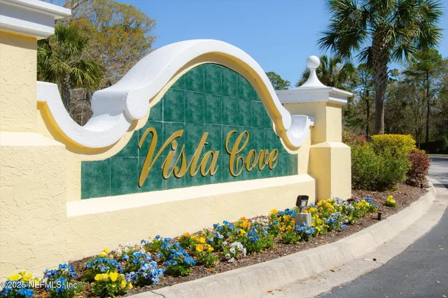 a view of a sign board with flower garden