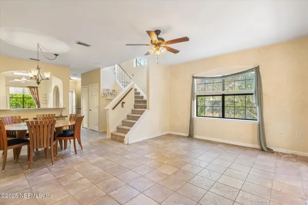 a view of a livingroom with furniture and a ceiling fan