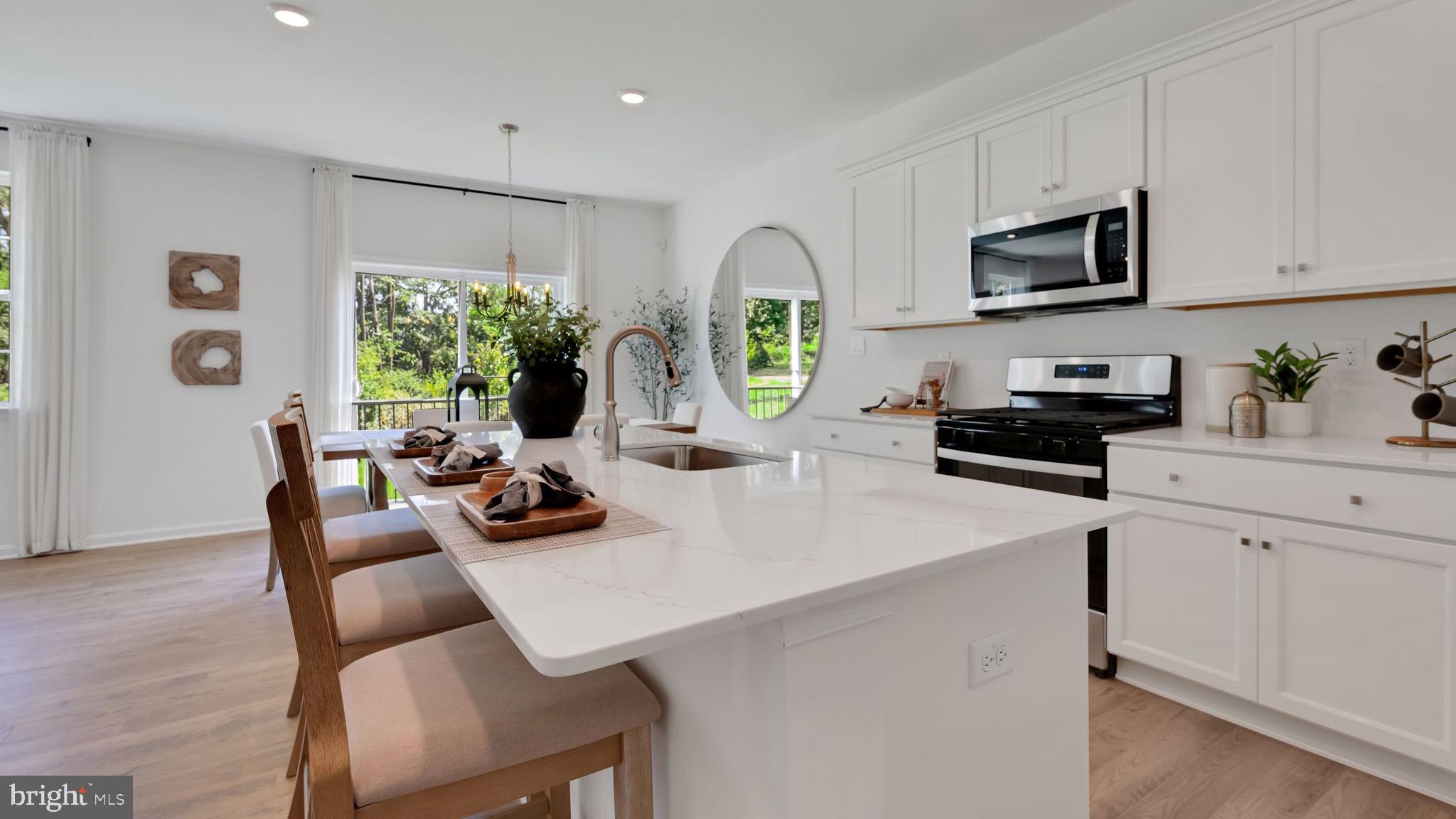 109 Pear Rdg Drive Harrisburg, PA 17111 - Photo 2 of 28 a kitchen with stainless steel appliances a white table chairs and a refrigerator