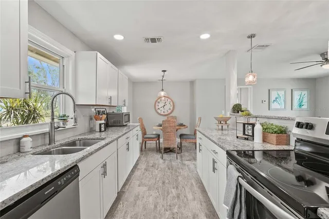 a large kitchen with granite countertop a lot of counter space