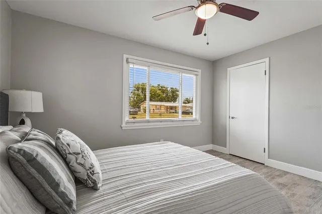 a bedroom with bed and a window