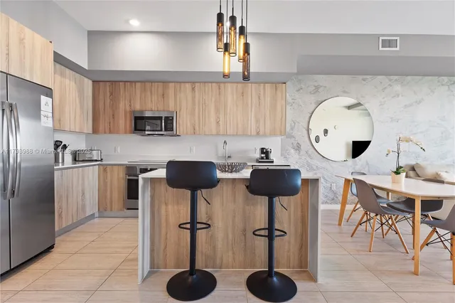 a kitchen with furniture a refrigerator and a sink