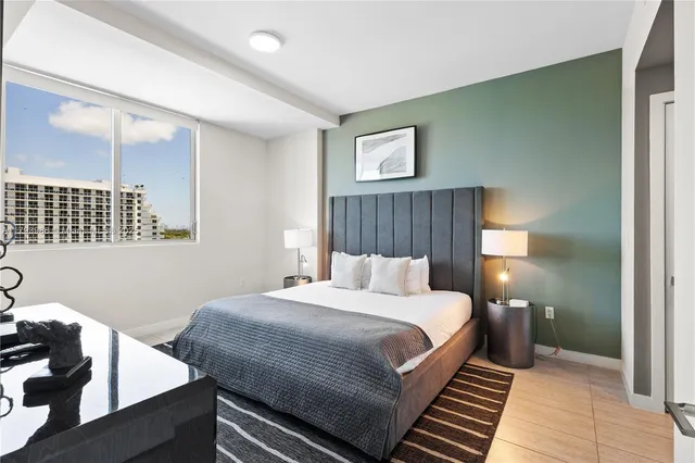 a bedroom with a bed and lamps