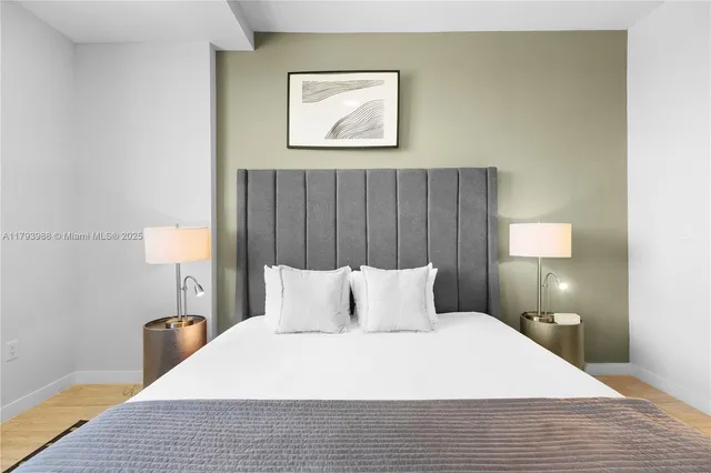 a bedroom with a bed and a lamp