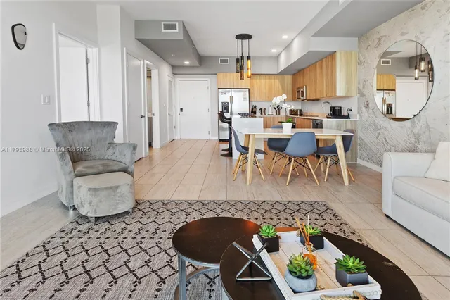 a living room with furniture and a chandelier