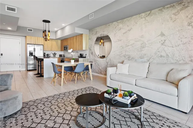 a living room with furniture and a dining table