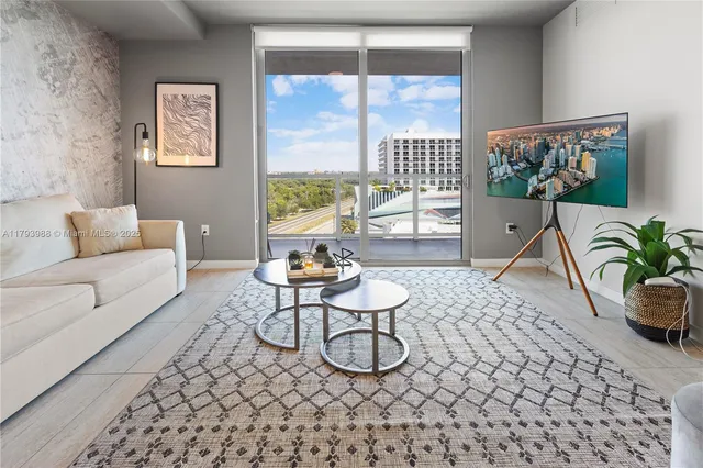 a living room with furniture a rug and a window