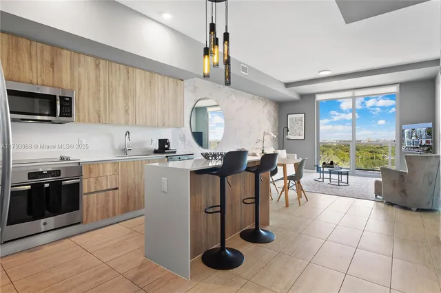 a kitchen with a sink a counter top space appliances and cabinets