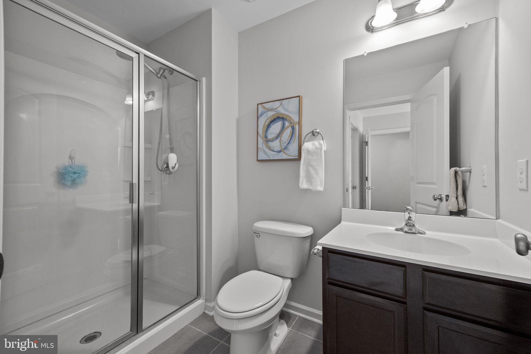 3669 Jacob Stout Road, Unit 9 Doylestown, PA 18902 - Photo 24 of 36 a bathroom with a toilet sink vanity and shower