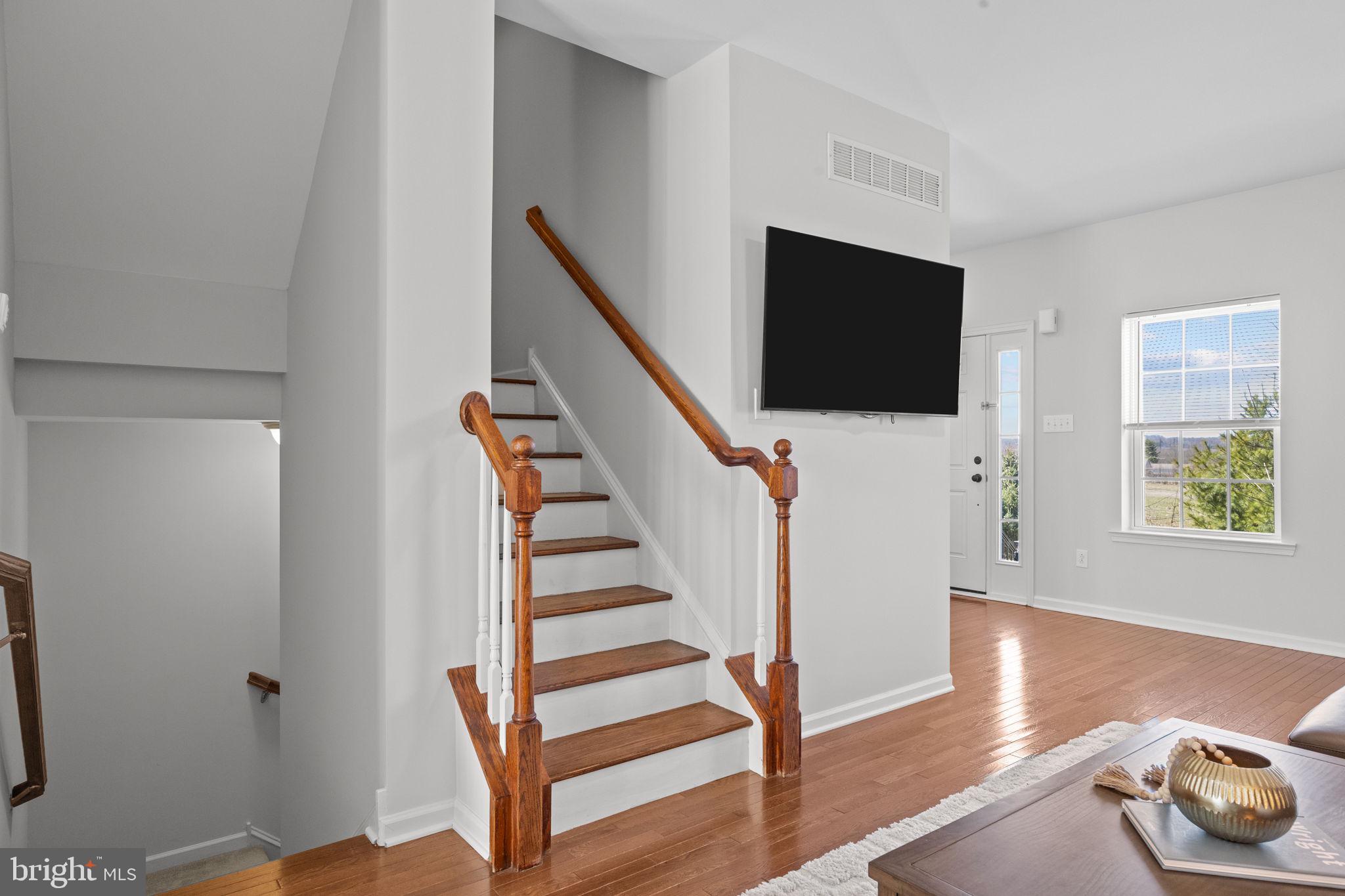 3669 Jacob Stout Road, Unit 9 Doylestown, PA 18902 - Photo 8 of 36 a view of entryway with wooden floor and stairs