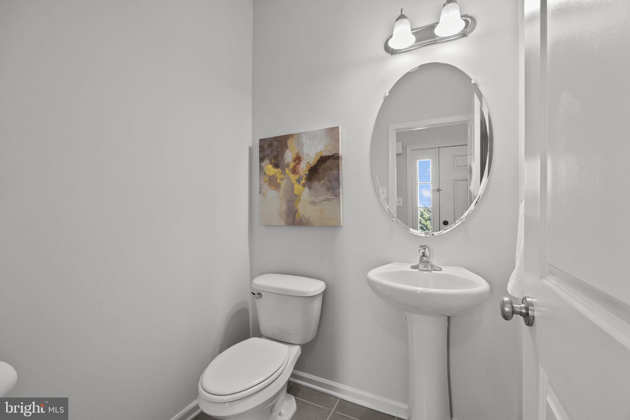 3669 Jacob Stout Road, Unit 9 Doylestown, PA 18902 - Photo 9 of 36 a bathroom with a toilet sink and mirror