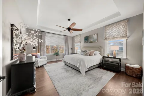 a spacious bedroom with a bed a couch and dresser